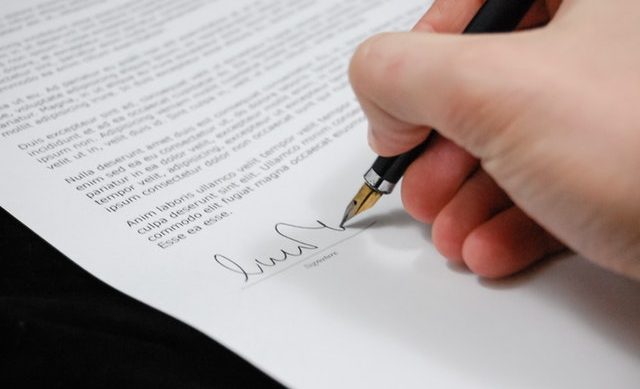Man signing document